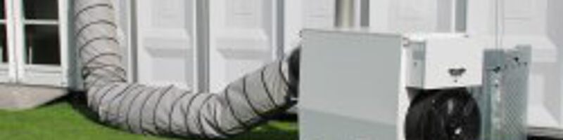 AdobeStock_363310791 Mobiles Heizsystem steht hinter einem Haus