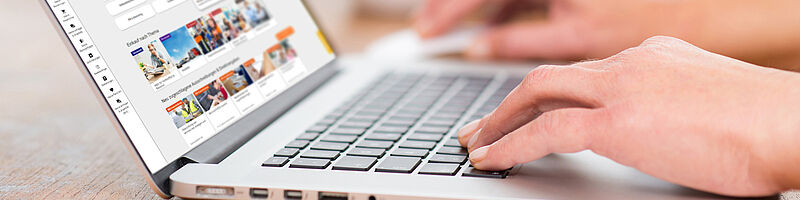 Portal_Fotolia_128145869_mit_Screenshot_DRUCK Hände liegen auf Tastatur eines Laptops, am Bildschirm der e-Shop der BBG